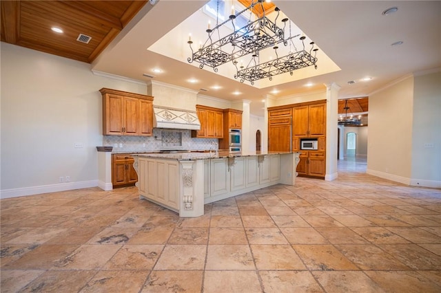 178 Hampton Point Dr, Saint Simons Island, GA 31522 - kitchen featuring a chandelier, brown cabinets, decorative backsplash, stone tile floors, and recessed lighting