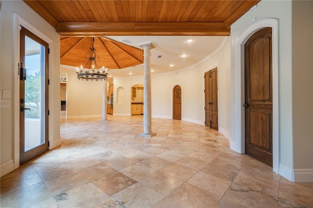 178 Hampton Point Dr, Saint Simons Island, GA 31522 - spare room with arched walkways, a chandelier, a wood ceiling with exposed beams, stone tile flooring, and ornamental molding