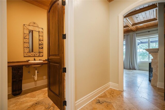 178 Hampton Point Dr, Saint Simons Island, GA 31522 - hallway featuring a wood ceiling with exposed beams, arched walkways, and light tile patterned floors
