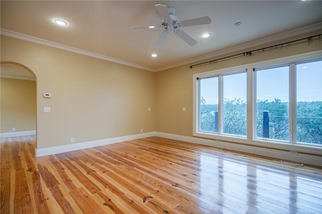 178 Hampton Point Dr, Saint Simons Island, GA 31522 - empty room with crown molding, arched walkways, ceiling fan, light wood-type flooring, and recessed lighting