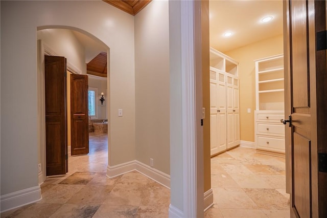 178 Hampton Point Dr, Saint Simons Island, GA 31522 - corridor with arched walkways, light stone finish flooring, and crown molding