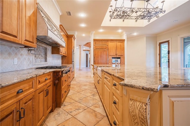 178 Hampton Point Dr, Saint Simons Island, GA 31522 - kitchen featuring stainless steel gas stovetop, custom exhaust hood, tasteful backsplash, crown molding, and light stone countertops