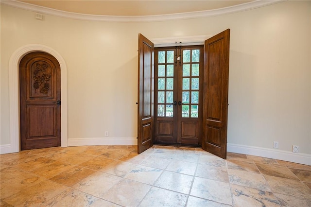 178 Hampton Point Dr, Saint Simons Island, GA 31522 - foyer featuring stone tile floors, french doors, ornamental molding, and arched walkways