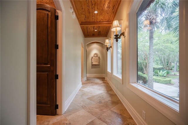 178 Hampton Point Dr, Saint Simons Island, GA 31522 - hallway with arched walkways, wooden ceiling, and stone tile floors