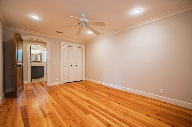 178 Hampton Point Dr, Saint Simons Island, GA 31522 - unfurnished bedroom with ornamental molding, arched walkways, recessed lighting, light wood finished floors, and ensuite bath