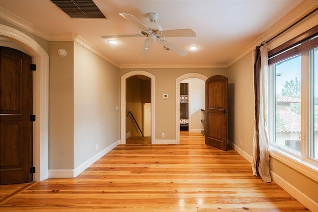 178 Hampton Point Dr, Saint Simons Island, GA 31522 - unfurnished room featuring arched walkways, crown molding, light wood-style flooring, a smoke detector, and ceiling fan