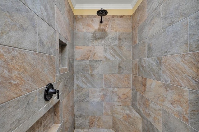 interior details featuring tiled shower and ornamental molding