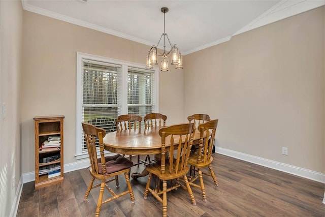 dining space featuring dark wood-type flooring, ornamental molding, and a notable chandelier