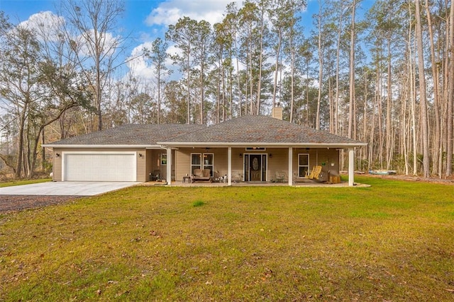 view of front of house with a garage, covered porch, and a front lawn