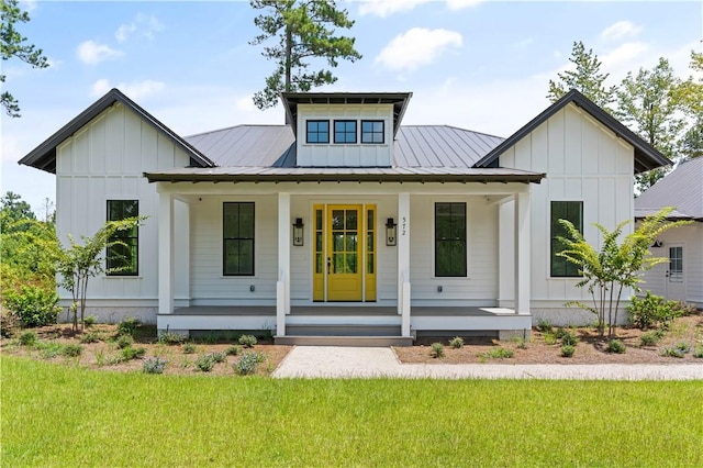 modern farmhouse style home with a front yard and a porch