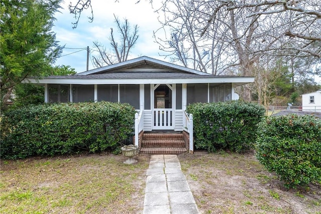 bungalow-style home with a shingled roof