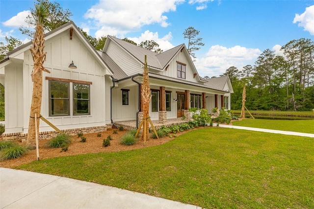 128 W Point Pkwy, Saint Simons Island, GA 31522 - modern inspired farmhouse with board and batten siding, covered porch, and a front yard