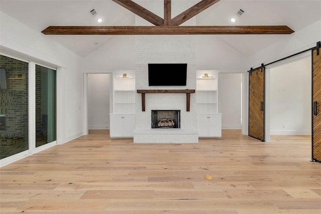 128 W Point Pkwy, Saint Simons Island, GA 31522 - unfurnished living room featuring a large fireplace, a barn door, light wood-style flooring, baseboards, and recessed lighting