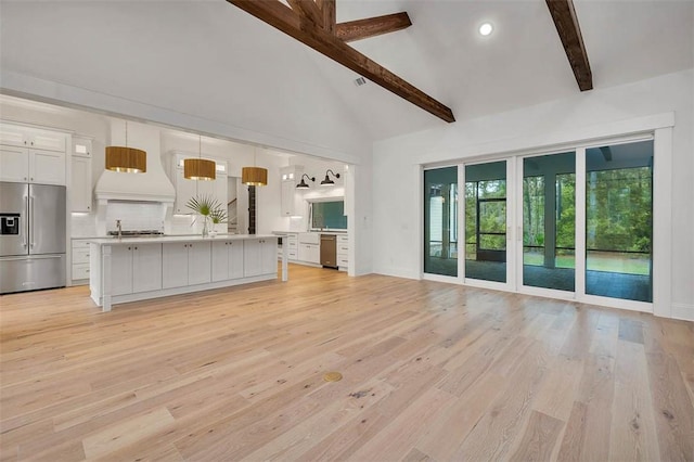 128 W Point Pkwy, Saint Simons Island, GA 31522 - unfurnished living room with beamed ceiling, light wood finished floors, baseboards, high vaulted ceiling, and recessed lighting