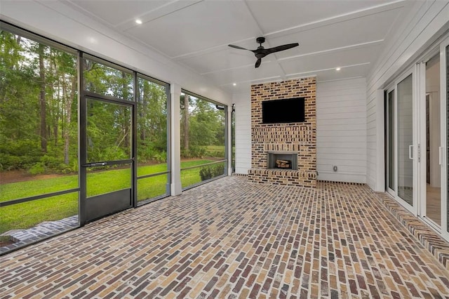 128 W Point Pkwy, Saint Simons Island, GA 31522 - unfurnished sunroom with a brick fireplace and a ceiling fan