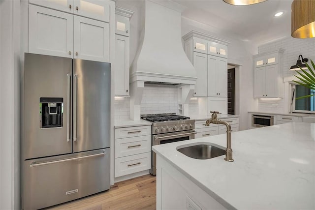 128 W Point Pkwy, Saint Simons Island, GA 31522 - kitchen featuring high quality appliances, premium range hood, a sink, backsplash, and recessed lighting