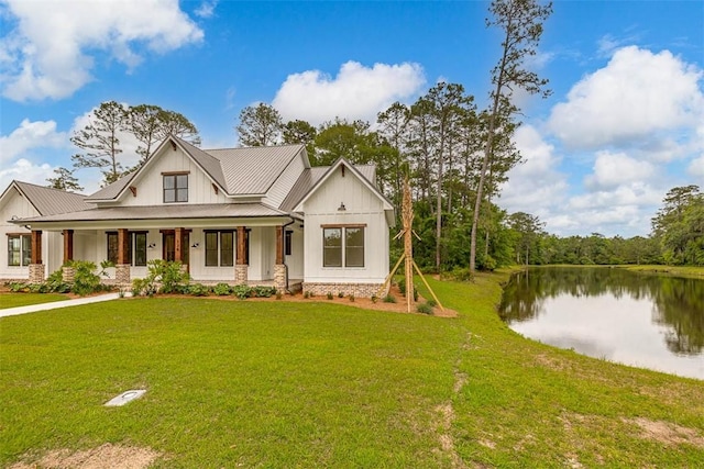 128 W Point Pkwy, Saint Simons Island, GA 31522 - modern farmhouse featuring board and batten siding, a porch, a water view, metal roof, and a front yard