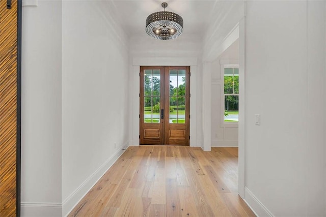 128 W Point Pkwy, Saint Simons Island, GA 31522 - doorway to outside with light wood-style flooring, baseboards, french doors, and a chandelier