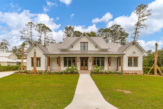 128 W Point Pkwy, Saint Simons Island, GA 31522 - modern inspired farmhouse with a porch, board and batten siding, and a front lawn