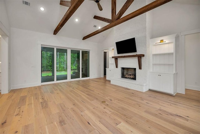 128 W Point Pkwy, Saint Simons Island, GA 31522 - unfurnished living room featuring high vaulted ceiling, a large fireplace, baseboards, beam ceiling, and wood finished floors