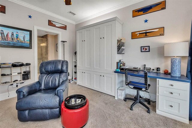 office with built in desk, light colored carpet, and ornamental molding