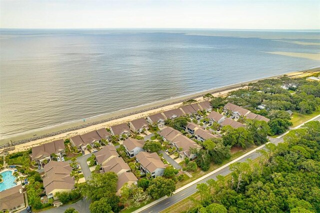 aerial view with a water view and a beach view