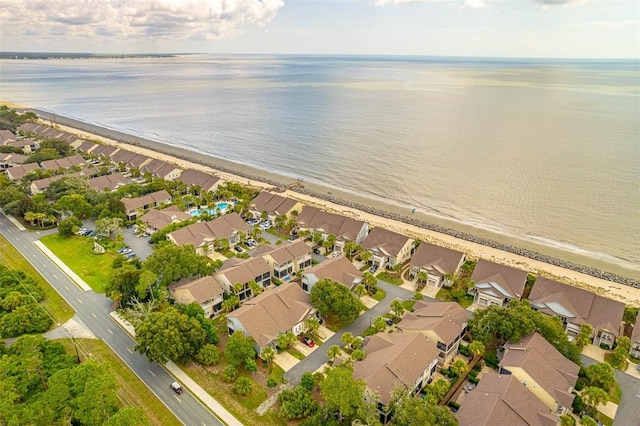 birds eye view of property with a water view and a view of the beach