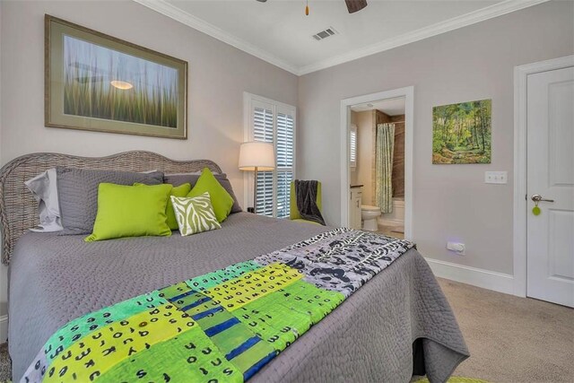 bedroom with carpet floors, ensuite bathroom, crown molding, and ceiling fan