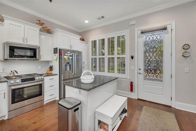 kitchen with white cabinets, dark wood-type flooring, and appliances with stainless steel finishes