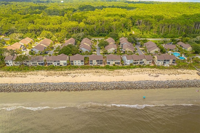 bird's eye view featuring a water view and a beach view