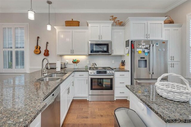 kitchen with sink, ornamental molding, light hardwood / wood-style floors, white cabinetry, and stainless steel appliances