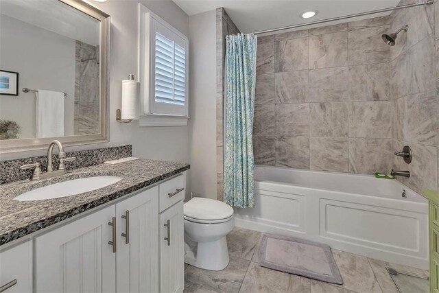 full bathroom with vanity, toilet, and shower / bath combo with shower curtain