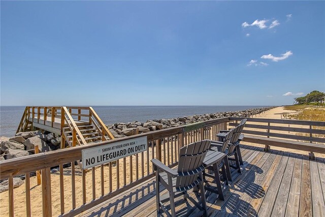 wooden terrace featuring a water view