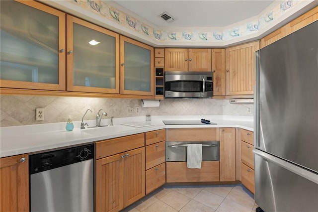 345 Moss Oak Cir, Saint Simons Island, GA 31522 - kitchen featuring stainless steel appliances, light countertops, tasteful backsplash, light tile patterned floors, and a warming drawer