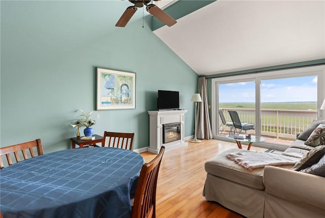 345 Moss Oak Cir, Saint Simons Island, GA 31522 - living room with a glass covered fireplace, ceiling fan, wood finished floors, and lofted ceiling