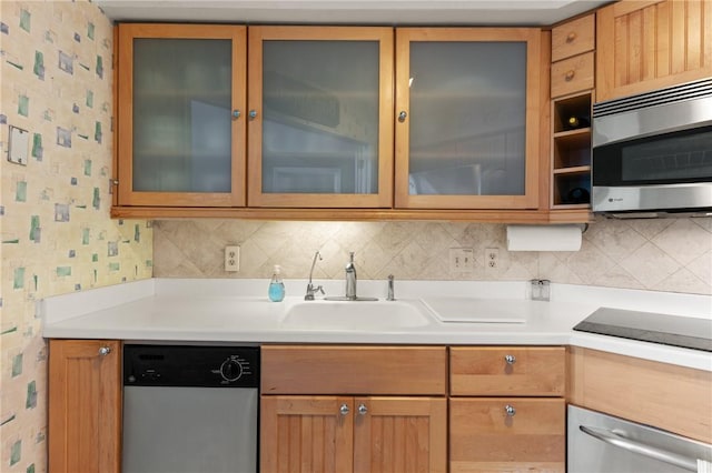 345 Moss Oak Cir, Saint Simons Island, GA 31522 - kitchen featuring appliances with stainless steel finishes, wallpapered walls, light countertops, glass insert cabinets, and decorative backsplash