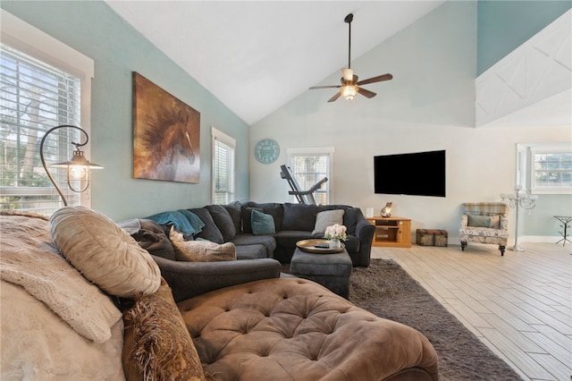 living room featuring a ceiling fan, high vaulted ceiling, and wood finished floors