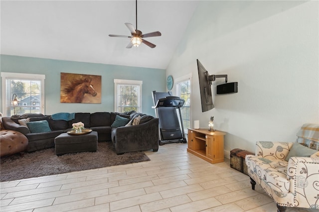 living area featuring light wood-style flooring, high vaulted ceiling, and ceiling fan