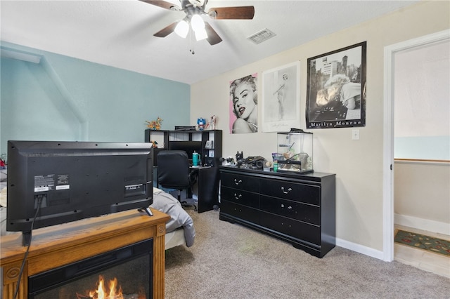 office featuring carpet, visible vents, ceiling fan, and baseboards