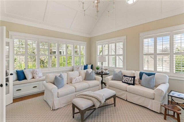 sunroom with a healthy amount of sunlight and lofted ceiling