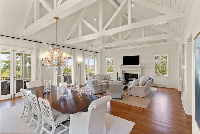 dining space with beamed ceiling, french doors, plenty of natural light, and dark wood-type flooring