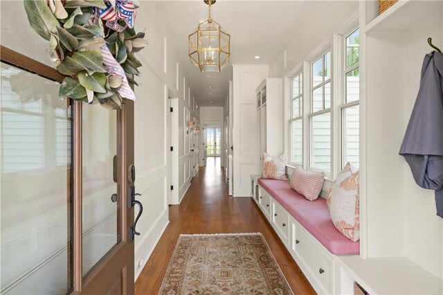 mudroom featuring dark hardwood / wood-style floors, an inviting chandelier, and a wealth of natural light