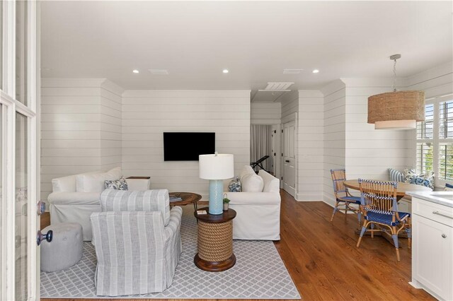 living room featuring wood walls and hardwood / wood-style floors