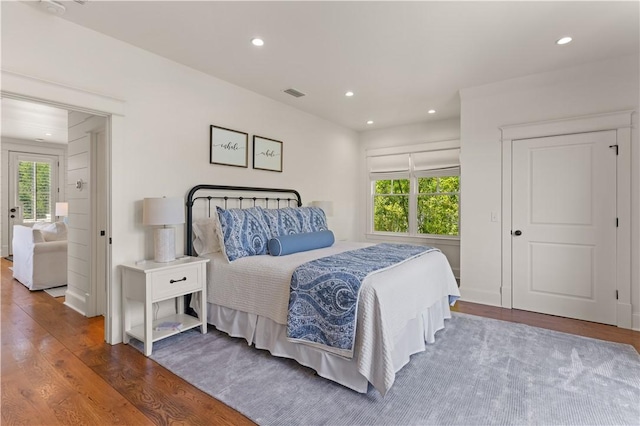 bedroom with hardwood / wood-style flooring