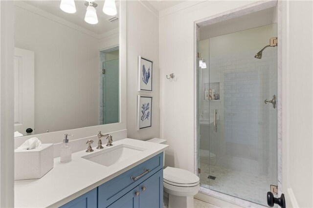 bathroom with toilet, vanity, an enclosed shower, and ornamental molding