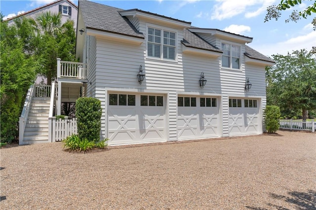 back of house featuring a garage