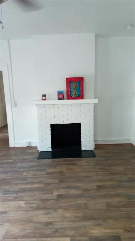 interior details featuring a fireplace, hardwood / wood-style floors, and ceiling fan