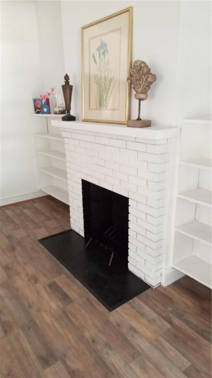 details featuring a brick fireplace and hardwood / wood-style flooring