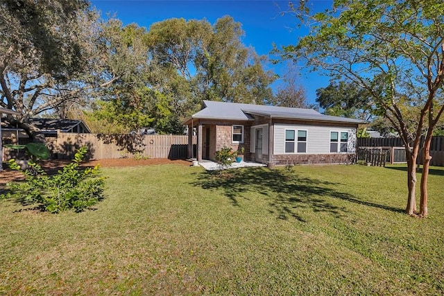 1106 George Lotson Ave, Saint Simons Island, GA 31522 - back of property with a yard, a fenced backyard, and stone siding