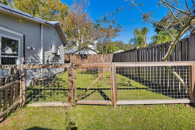 1106 George Lotson Ave, Saint Simons Island, GA 31522 - view of gate with a yard and a fenced backyard